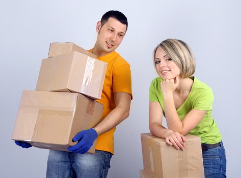 Mover wearing protective gloves and safety footwear during a relocation job