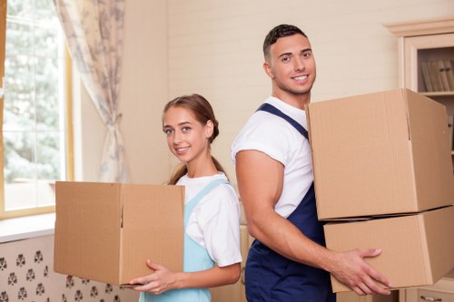 Specialist movers handling a piano in a Richmond townhouse